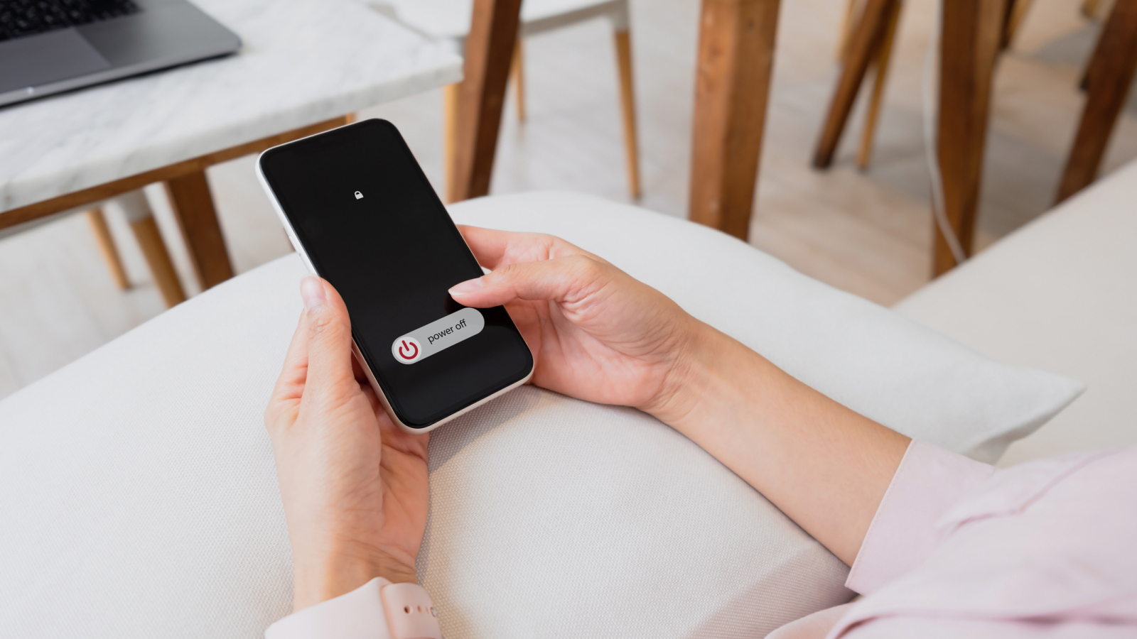 Woman hand using is sliding to turn off the mobile phone to reduce power consumption. Technology and environment concept